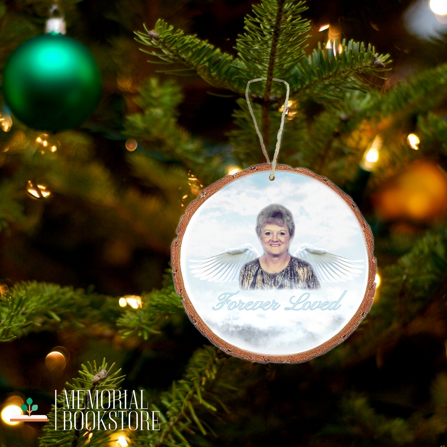 Personlized Wood Ornament with a picture of your loved one made into an angel in Heaven. Pictured on a Christmas tree for the holidays.